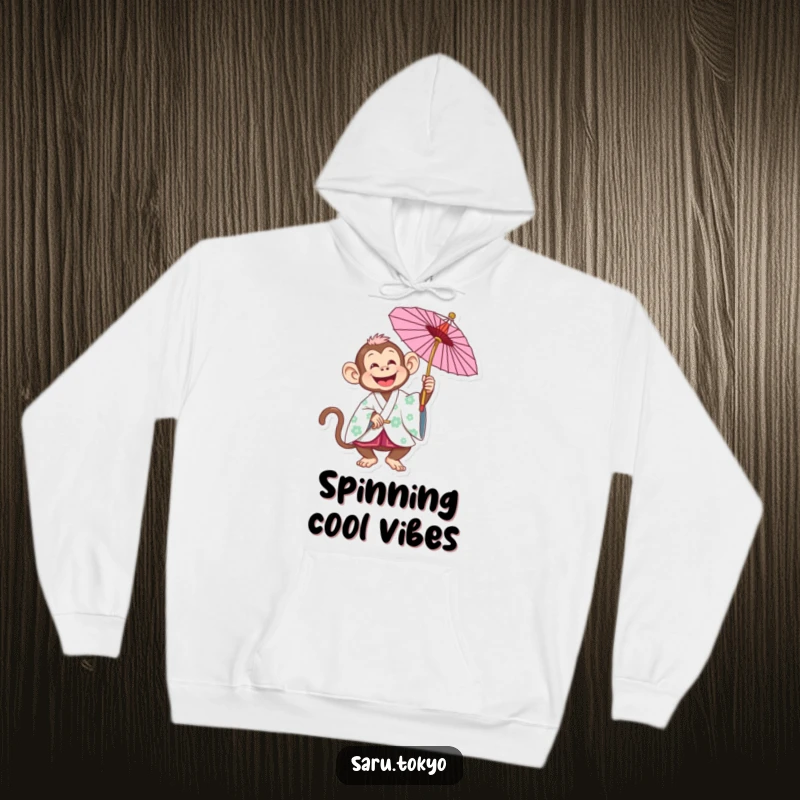 Funny Monkey Hoodie: Joyful monkey in a traditional kimono playfully spinning a parasol, embodying carefree fun.